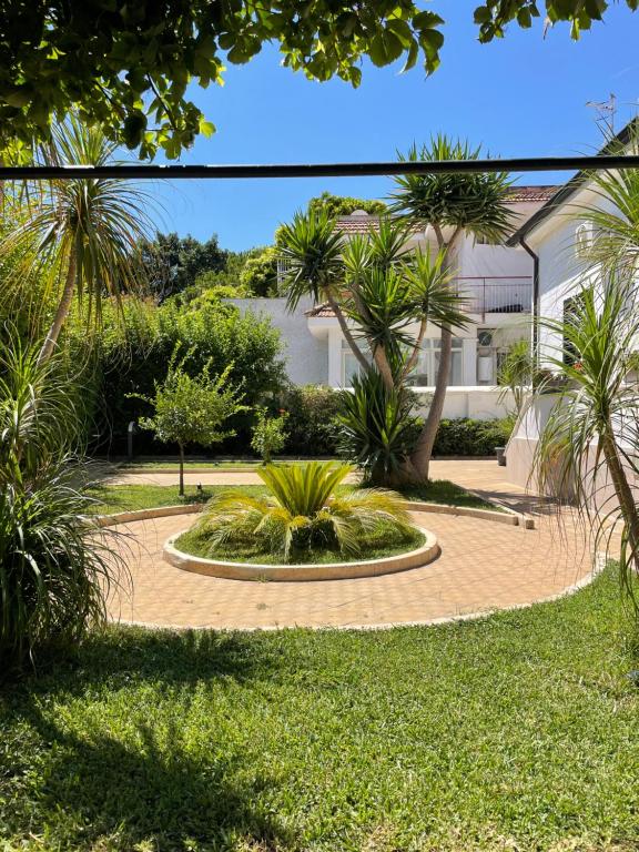 a garden with a fountain in the middle of a yard at Alemar Bed & Breakfast in Mondello