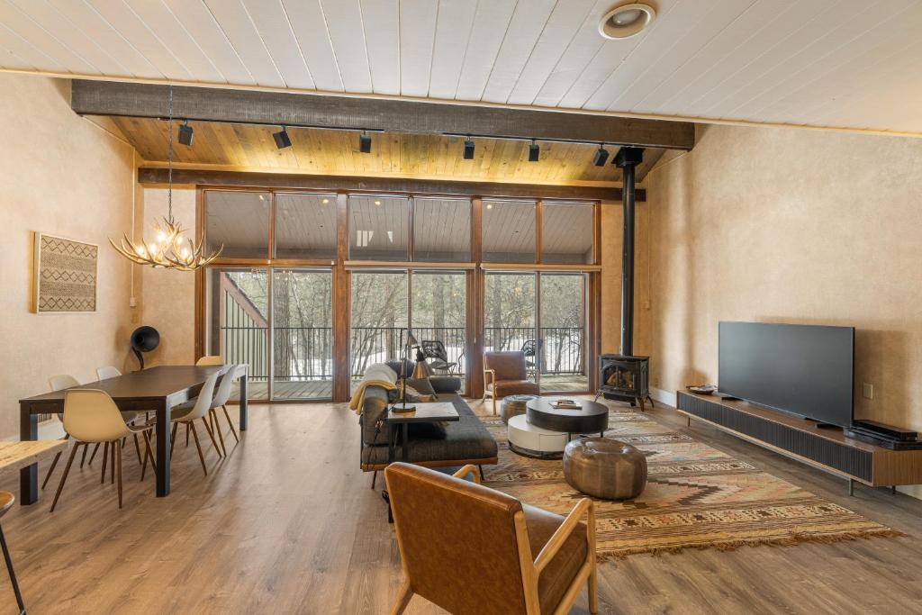 a living room with a couch and a table and a tv at Tamarron Lodge 752 & 753 in Durango