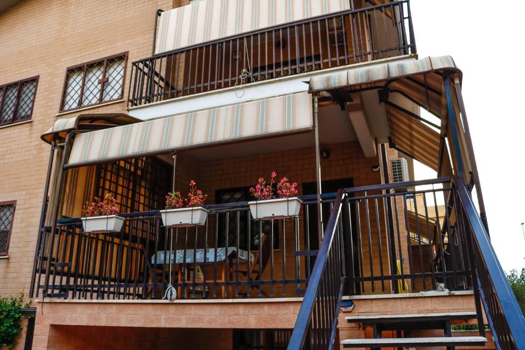 a building with a balcony with potted plants on it at La Posada Roma in Rome