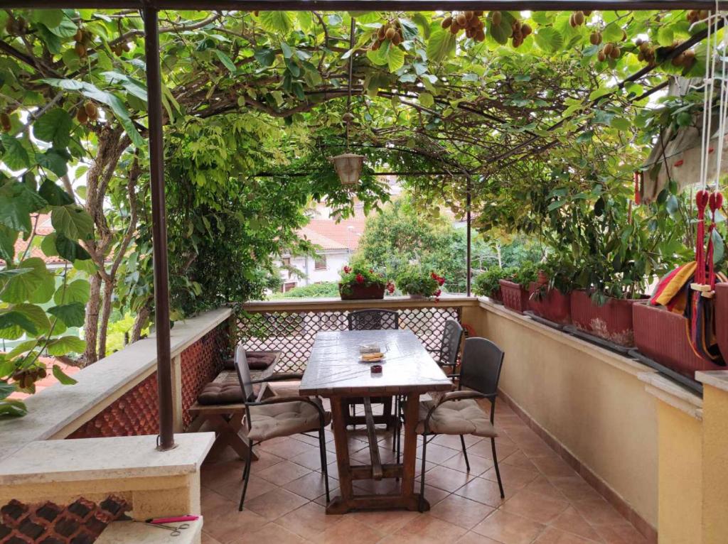a table and chairs on a balcony with trees at ArenaApp in Pula