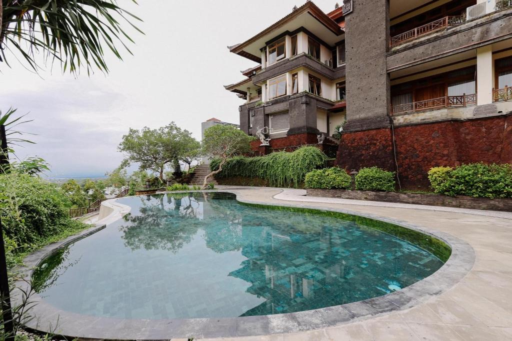 a swimming pool in front of a building at Langon Bali Resort by The Lavana in Nusa Dua