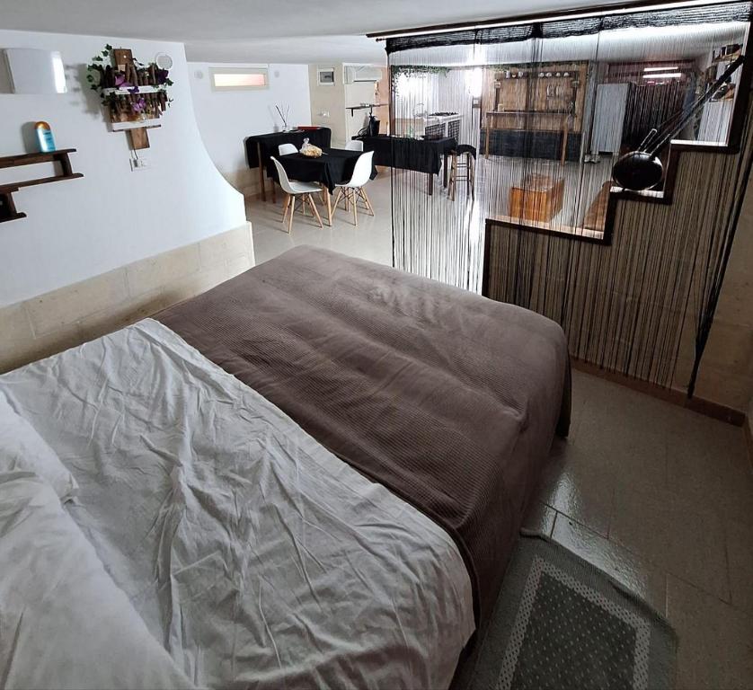 a bedroom with a large bed and a living room at Taberna di felisiano in Torre Canne