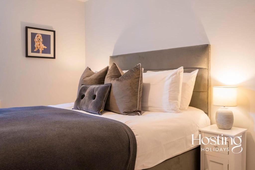 a bedroom with a large bed with white pillows at Walkers Paradise In The Heart Of The Chilterns in Henley on Thames