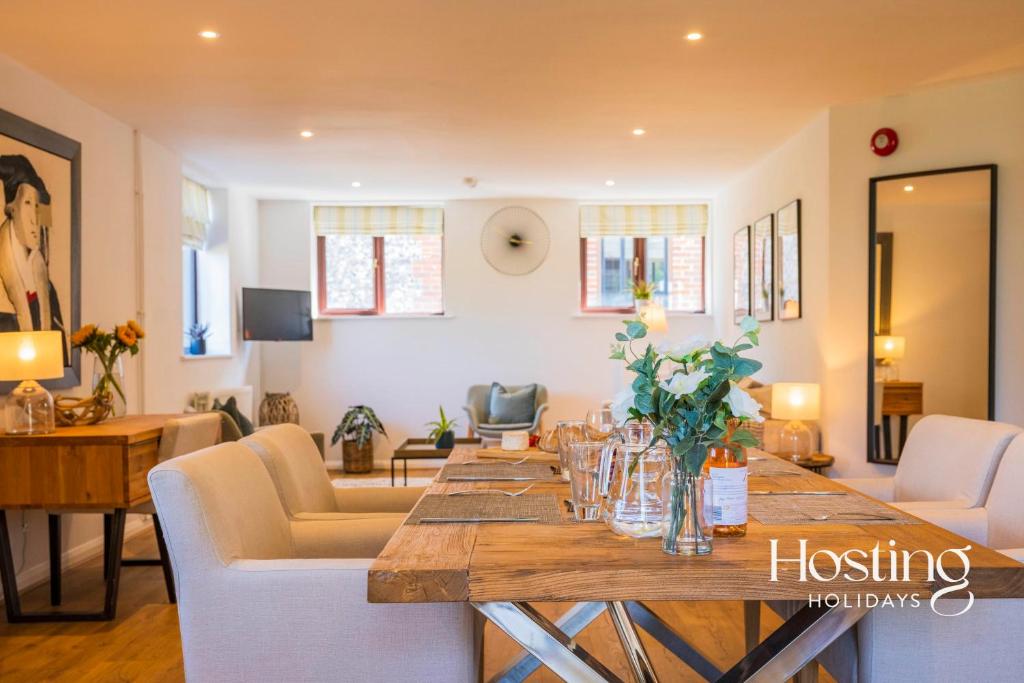 a living room with a long wooden table and chairs at Walkers Hideaway In The Heart Of The Chilterns With Incredible Views in Henley on Thames