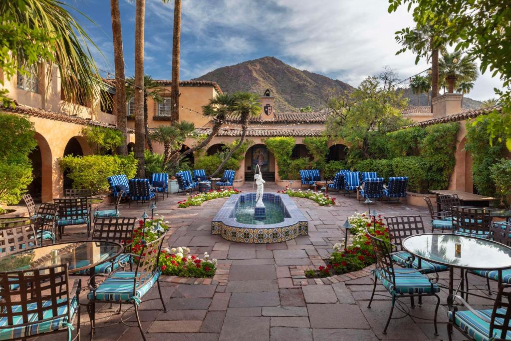 a courtyard with tables and chairs and a fountain at Royal Palms Resort and Spa, part of Hyatt in Phoenix