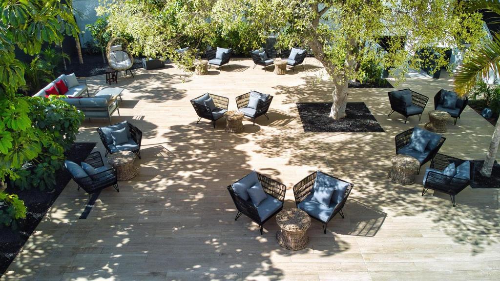 a group of black chairs sitting in a courtyard at HOVIMA Suites Costa Adeje in Adeje