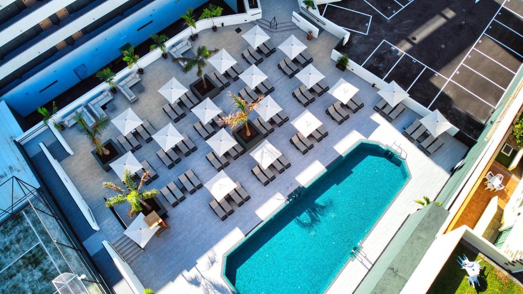 an overhead view of a pool with tables and chairs at HOVIMA Suites Costa Adeje in Adeje