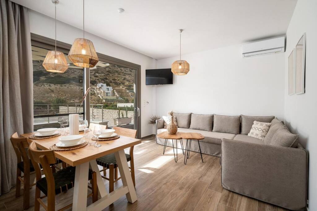 a living room with a table and a couch at Kayy Apartments 3 in Matala in Matala