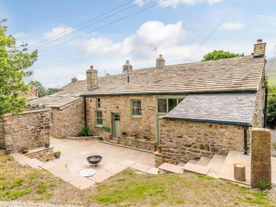 an old stone house with a patio in front of it at Martin's Farm House in Richmond