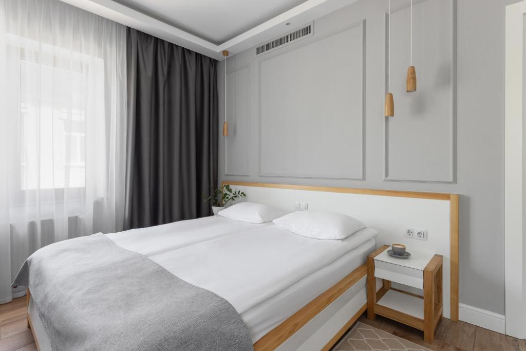 Postel nebo postele na pokoji v ubytování Frapolli 21 Hotel