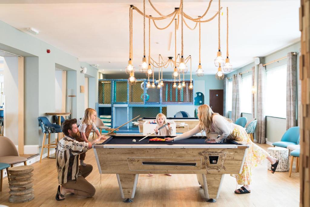 a group of people playing pool in a room at Esplanade Hotel in Newquay