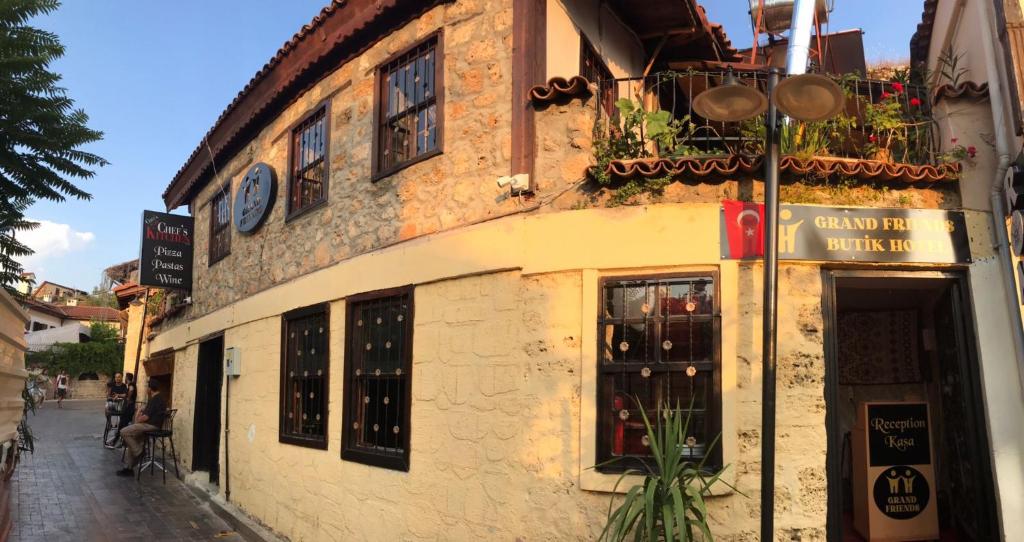 a building on a street with a wine store at grand friends in Antalya