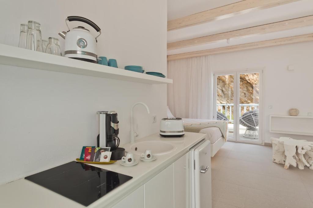 a kitchen with a counter with a coffee maker on it at Enilion Luxury Suites in Karpathos