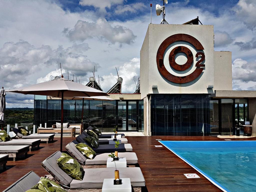 a building with a swimming pool and a resort at O2 Hotel Iguazu in Puerto Iguazú