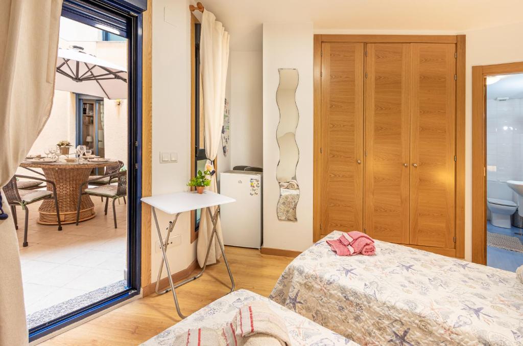 a room with two beds and a dining room at Altea Playa Roda in Altea