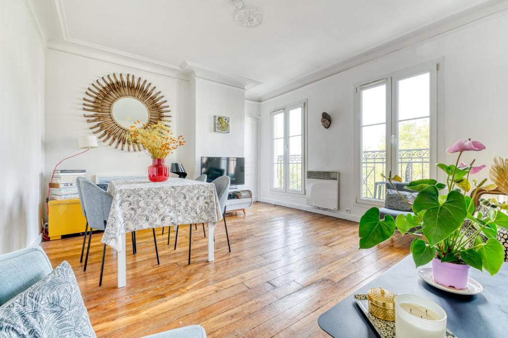 a dining room with a table and a mirror at Stunning Apartment 2br + balcony + nice view in Paris