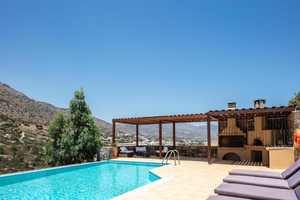 a villa with a swimming pool with a view at Maris Villas in Elounda