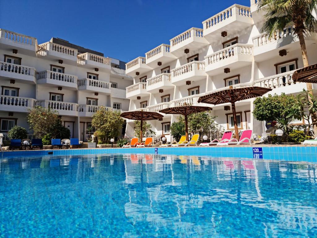 a large swimming pool in front of a building at Zak Inn in Hurghada