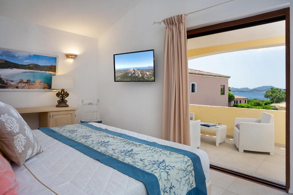 Postel nebo postele na pokoji v ubytování Hotel Capriccioli