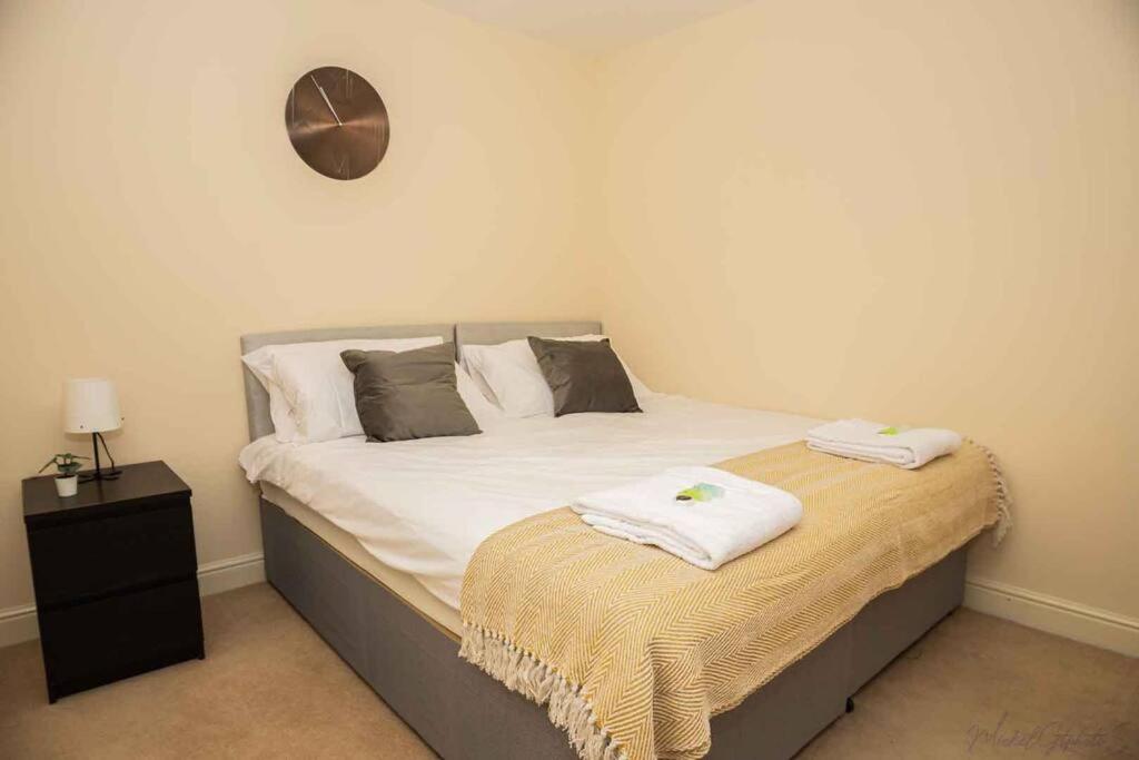 a bedroom with a bed with two towels on it at Clarkson Court 1Bedroom Flat in Hatfield