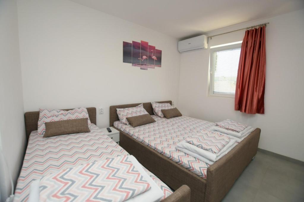 Postel nebo postele na pokoji v ubytování Olymp Apartmani