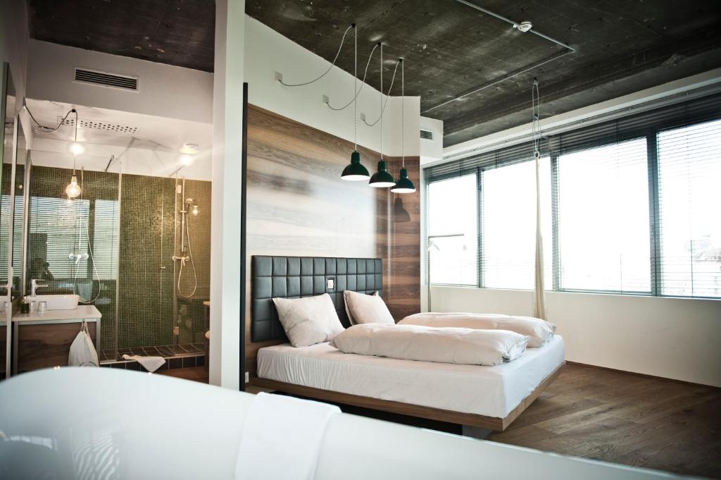 a bedroom with two beds and a bathroom at Hotel Daniel Vienna - Smart Lifestyle Near City Centre in Vienna