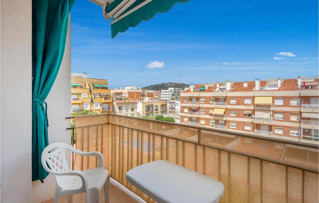 a balcony with a chair and a view of a city at Amazing Apartment In Pineda De Mar With Wifi in Pineda de Mar