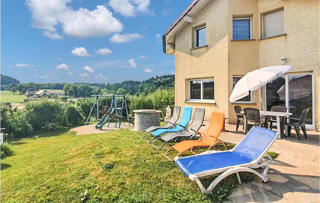 a group of chairs and an umbrella and a playground at Stunning Home In Ouhans With Wifi And 3 Bedrooms in Ouhans