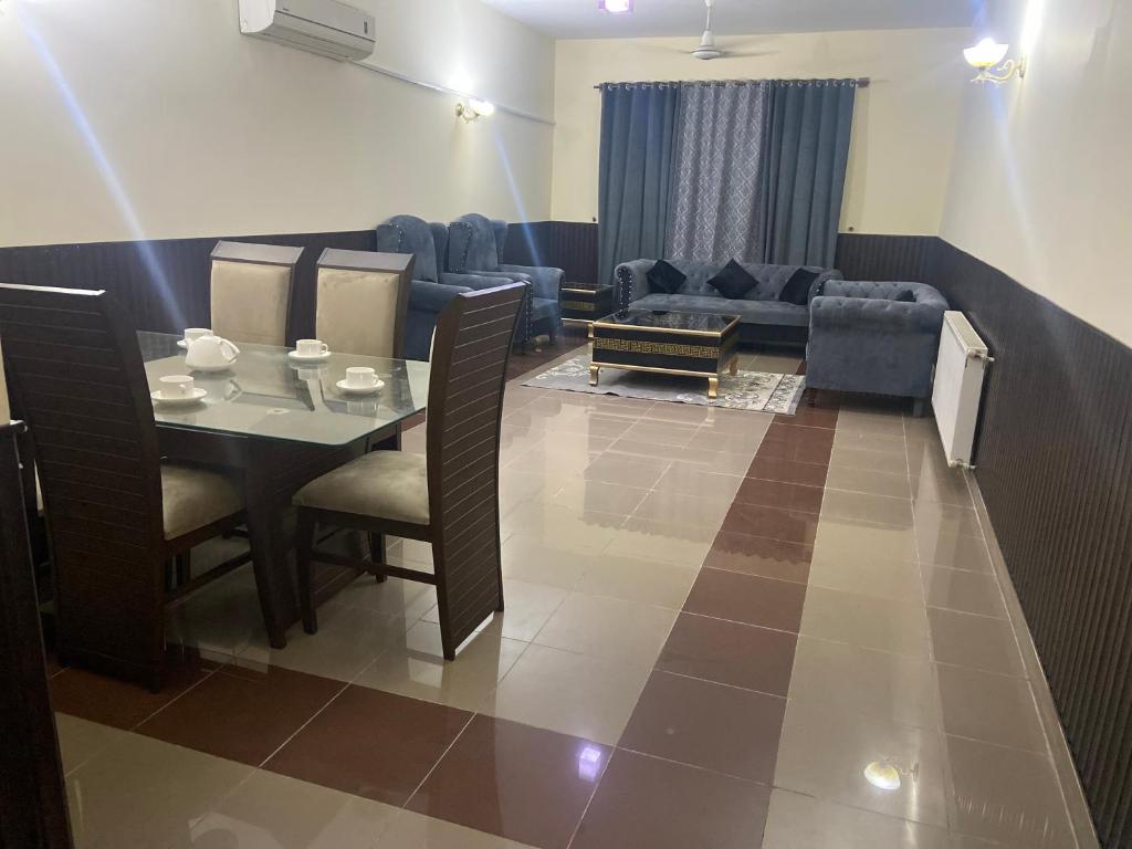 a living room with a table and a couch at 2 Bedroom Apartment F11 Islamabad - Askin in Islamabad