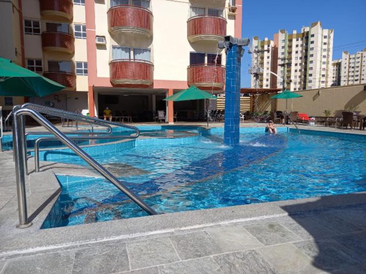 a swimming pool with blue water in a building at Splendor Thermas in Caldas Novas