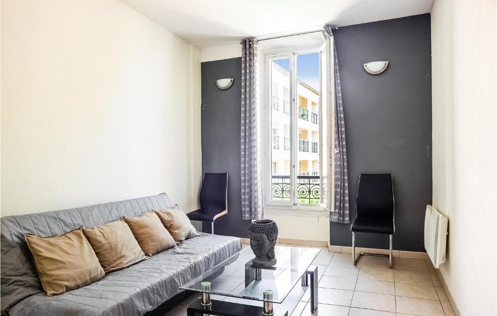 a living room with a couch and a window at Stunning Apartment In Marignane With Wifi And 1 Bedrooms in Marignane