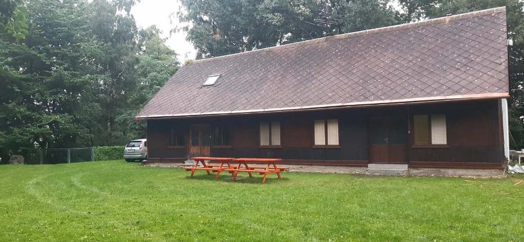 una casa con una mesa de picnic delante de ella en Chata Uhelka en Uhelná