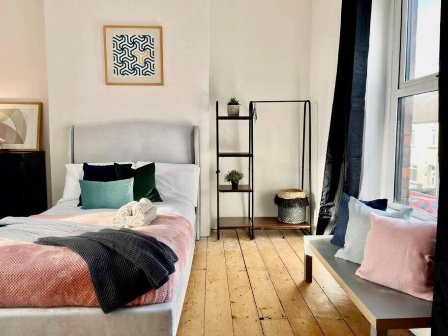 a bedroom with a bed and a mirror in it at Brewery Loft in Newport