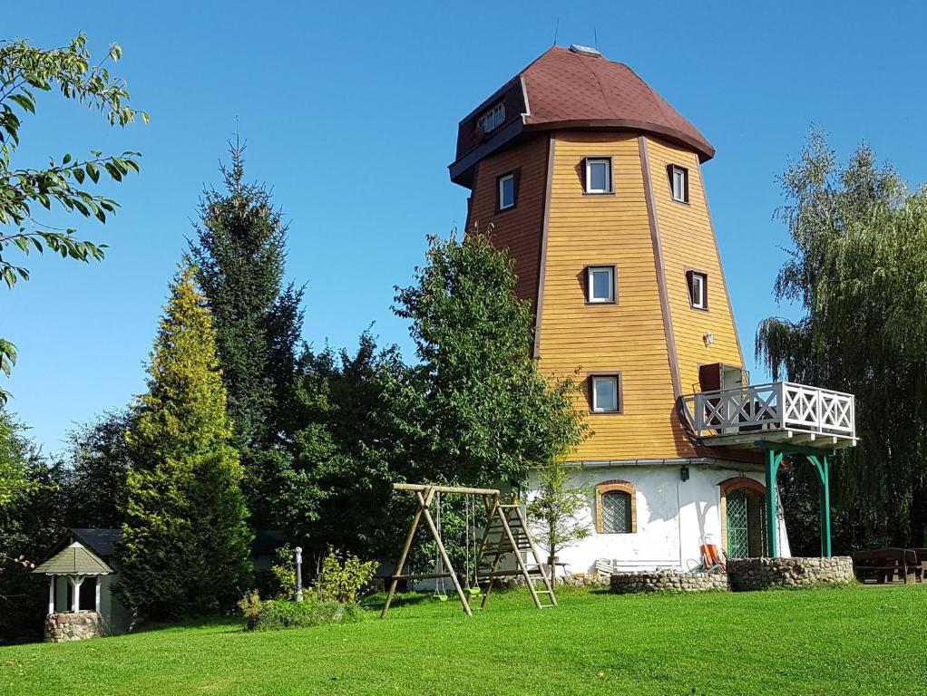 a building with a tower on top of it at Dom Mazurski Wiatrak in Giżycko