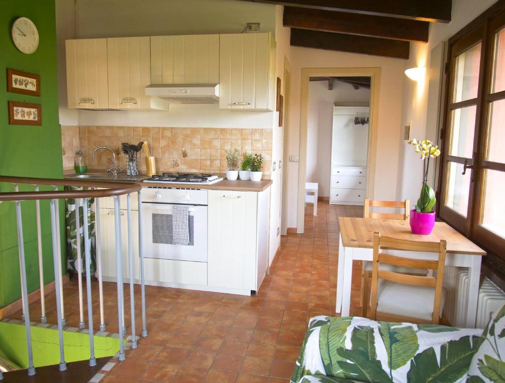 a kitchen with white cabinets and a table in a room at AC Ranch in Carentino