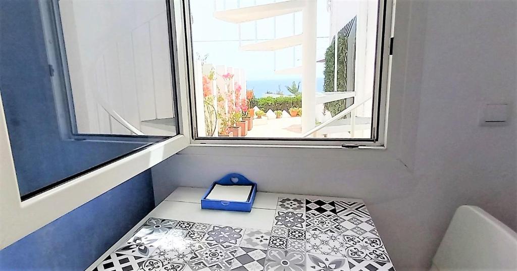 a small room with a window and a scale at Mandala Bungalows - Adults Only in Los Caños de Meca