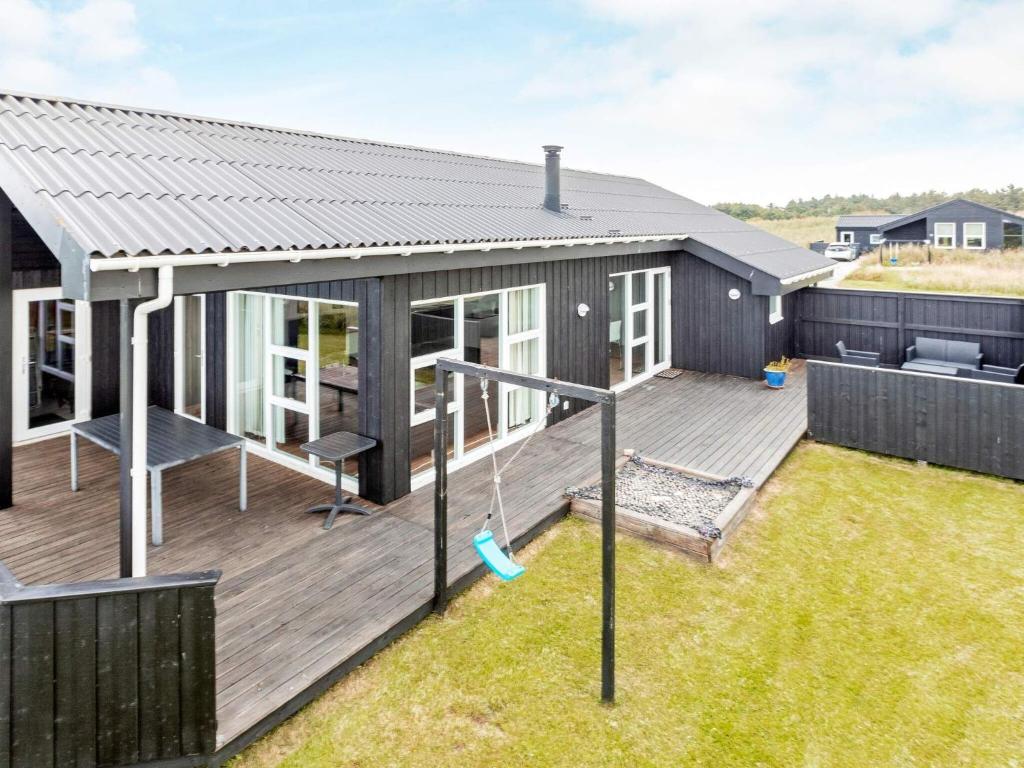 a modular home with a deck and patio at 6 person holiday home in Hirtshals in Hirtshals