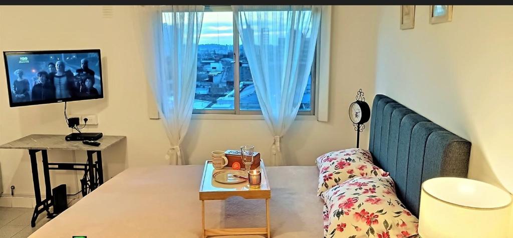 a living room with a couch and a window at Departamento Centrico Tandil 9 de Julio 454 in Tandil