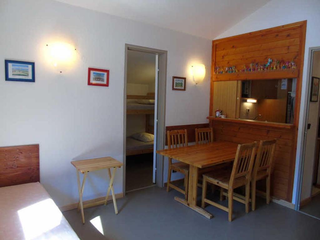 a room with a table and chairs and a bedroom at Studio Valfréjus, 1 pièce, 4 personnes - FR-1-561-63 in Valfréjus