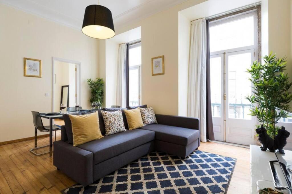a living room with a couch and a table at Ola Lisbon - Chiado 1 in Lisbon