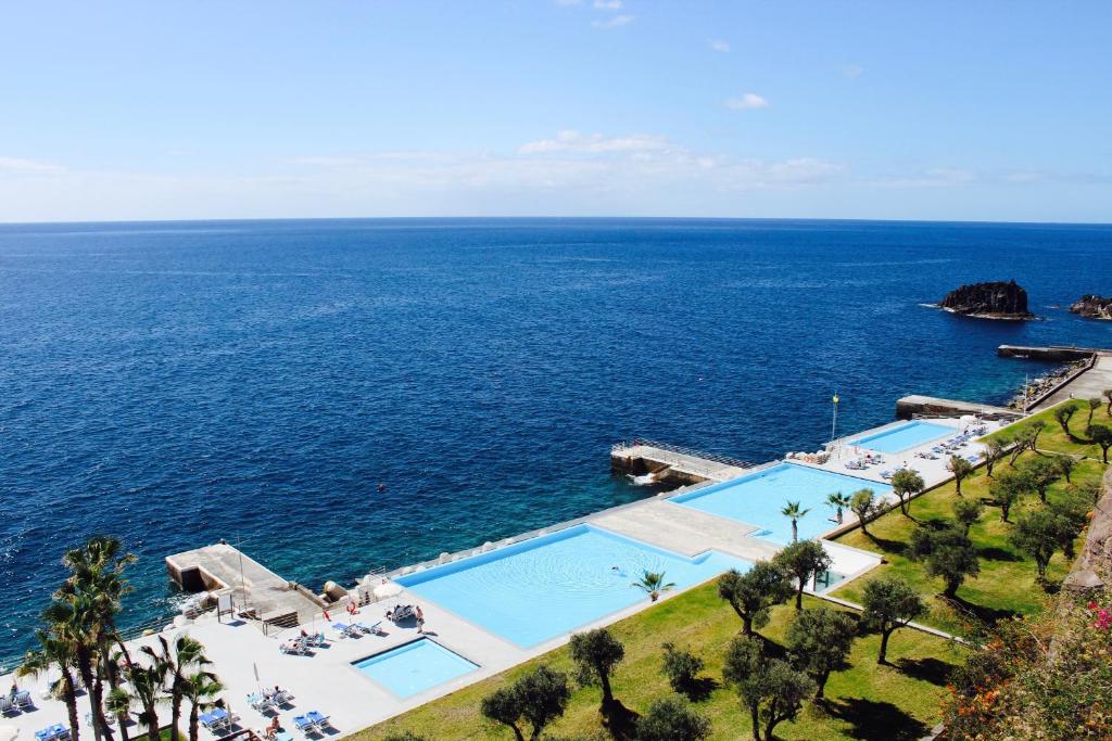 an aerial view of the ocean and a pool at VidaMar Resort Hotel Madeira - Dine Around Half Board in Funchal