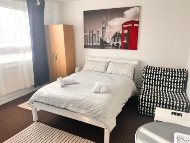 Beautiful Rooms close to Brick Lane في لندن: غرفة نوم عليها سرير وفوط