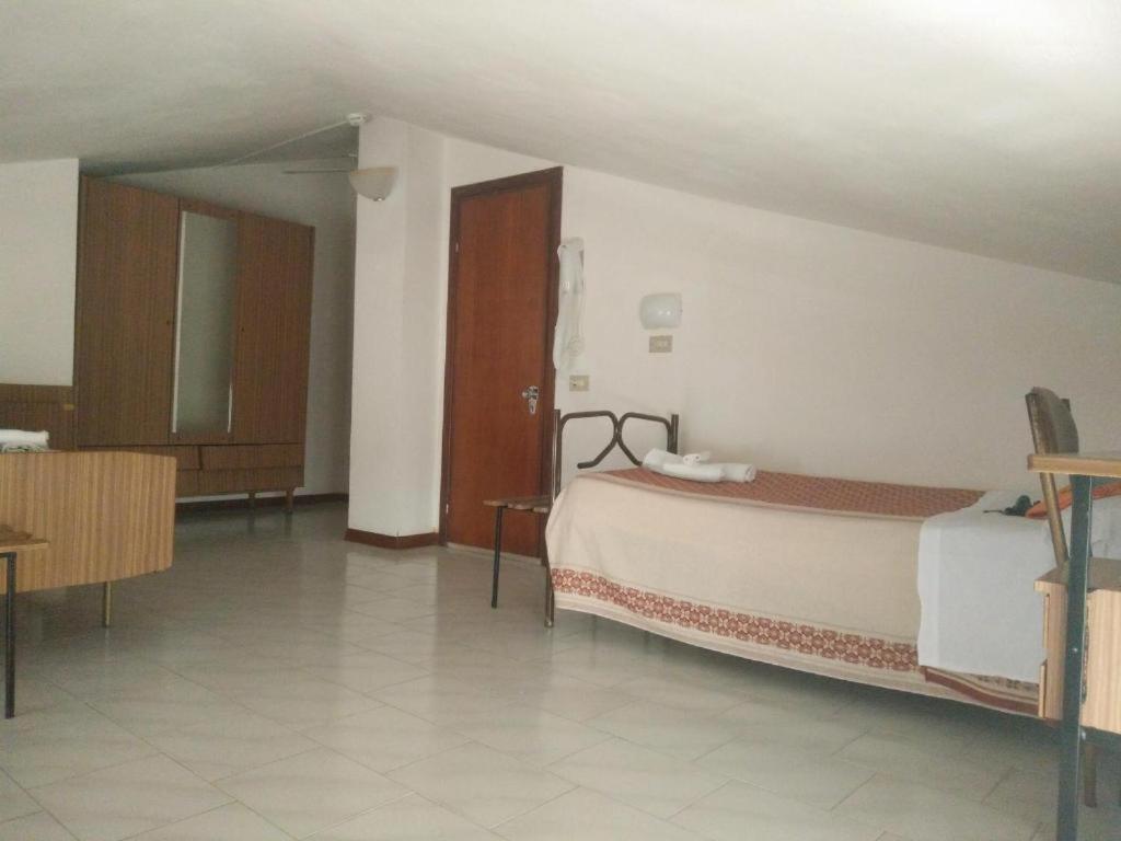 Postel nebo postele na pokoji v ubytování Hotel Peonia