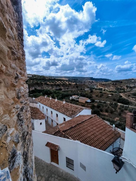 a view of the roofs of white buildings at CASA PUERTA ARABE - by Allexperiences in Setenil