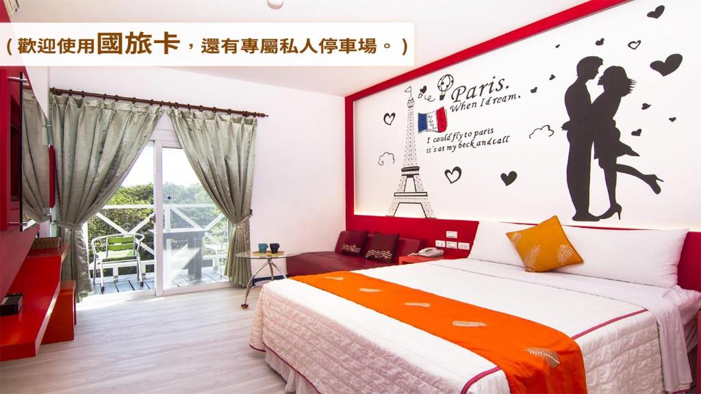 a bedroom with a bed and a wall with a poster at Ocean Star B&B in Kenting