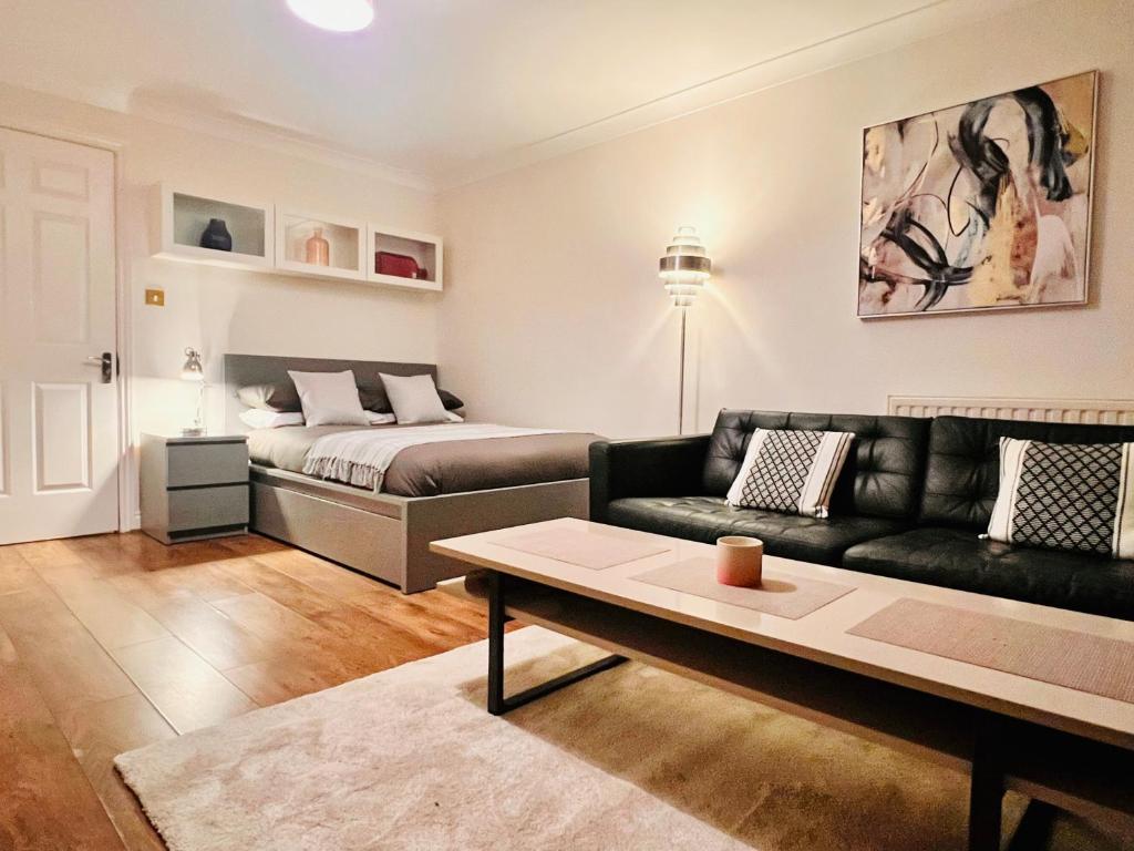 ein Wohnzimmer mit einem Sofa und einem Bett in der Unterkunft 42i Premium rooms London exactly like the photos in London