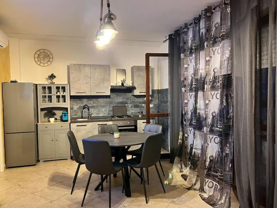 a kitchen with a table and chairs in a room at Casa FIBI in Ortona