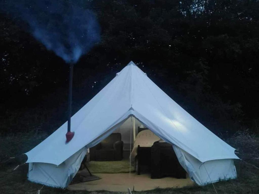 a white tent is lit up at night at Lainey's Rest in Wisbech