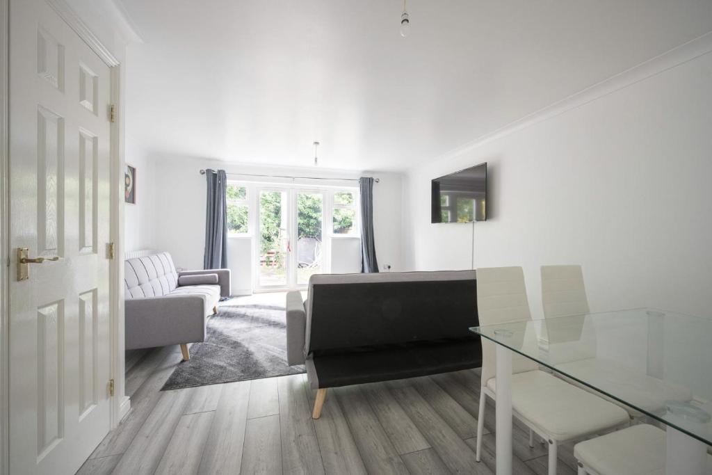 Kent的住宿－Maidstone villa 3 bedroom free sports channels,parking，带沙发和玻璃桌的客厅