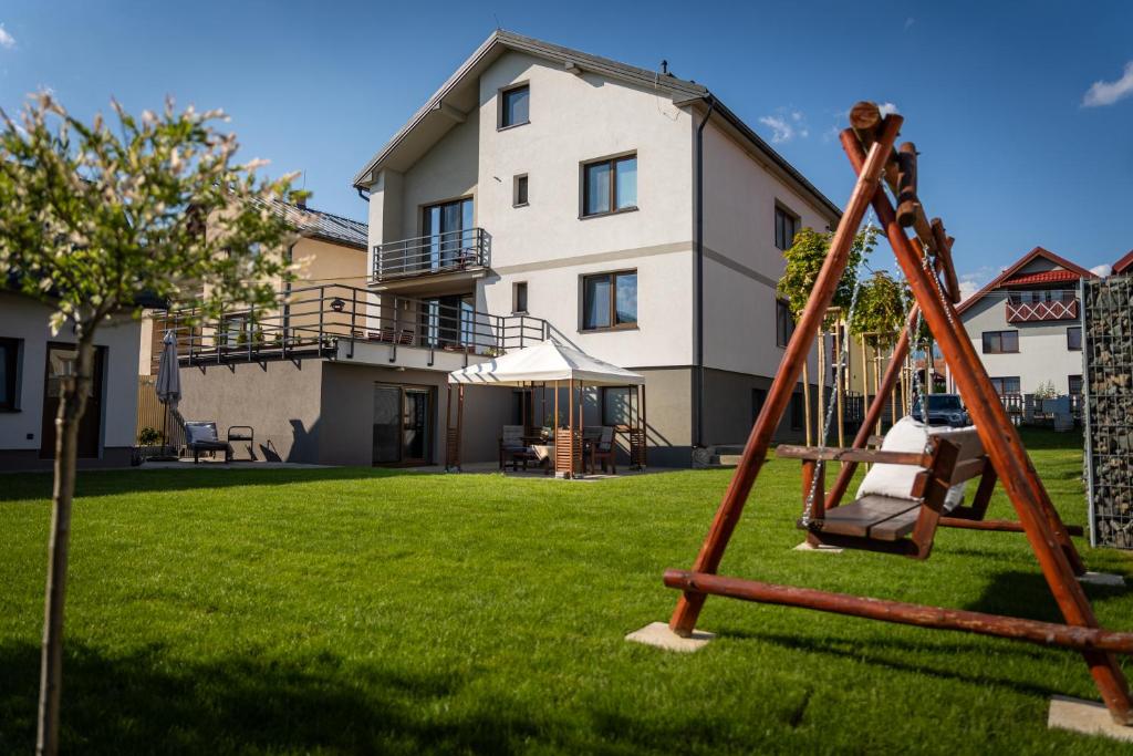 a swing in the yard of a house at Stylish apartment under the Tatras in Štrba